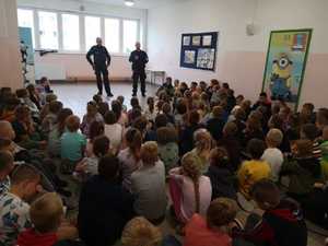 Policjanci dzielnicowi rozmawiający z dziećmi